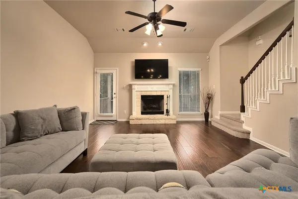 a living room with furniture and a fireplace