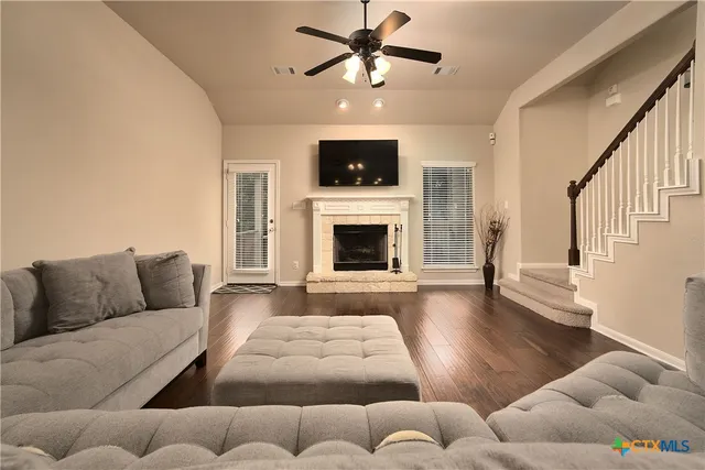 a living room with furniture and a fireplace