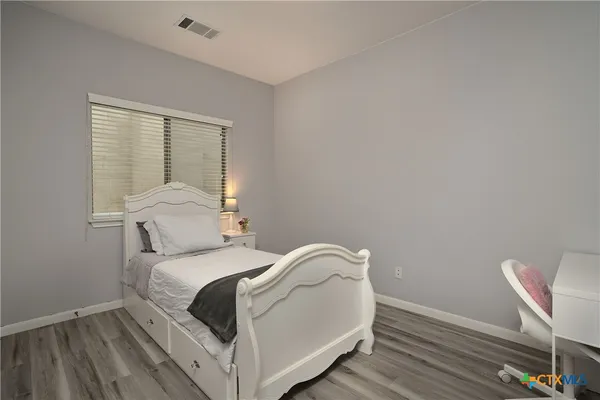 a bedroom with a bed and a chair