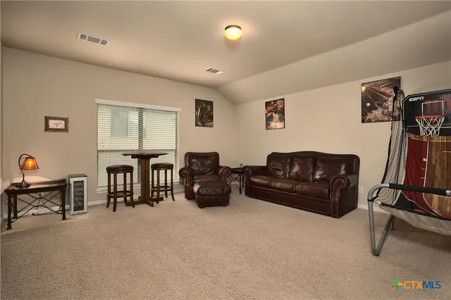 a living room with furniture gym equipment and a flat screen tv