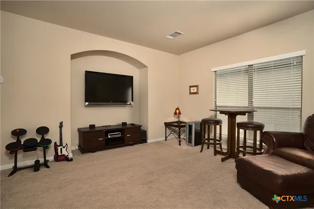 a livingroom with furniture and a flat screen tv