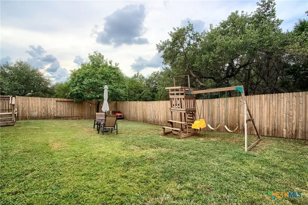 a view of a backyard with a slide and a slide