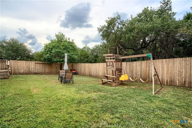 a view of a backyard with a slide and a slide
