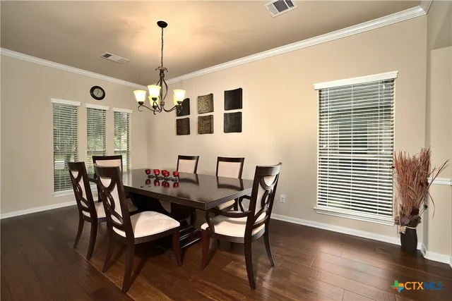 a dining room with furniture window and wooden floor