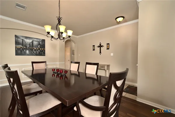 a view of a dining room with furniture and chandelier