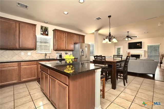 a kitchen with stainless steel appliances granite countertop a sink a stove counter space and cabinets