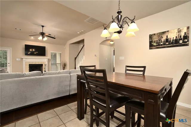 a living room with furniture a chandelier and a fireplace