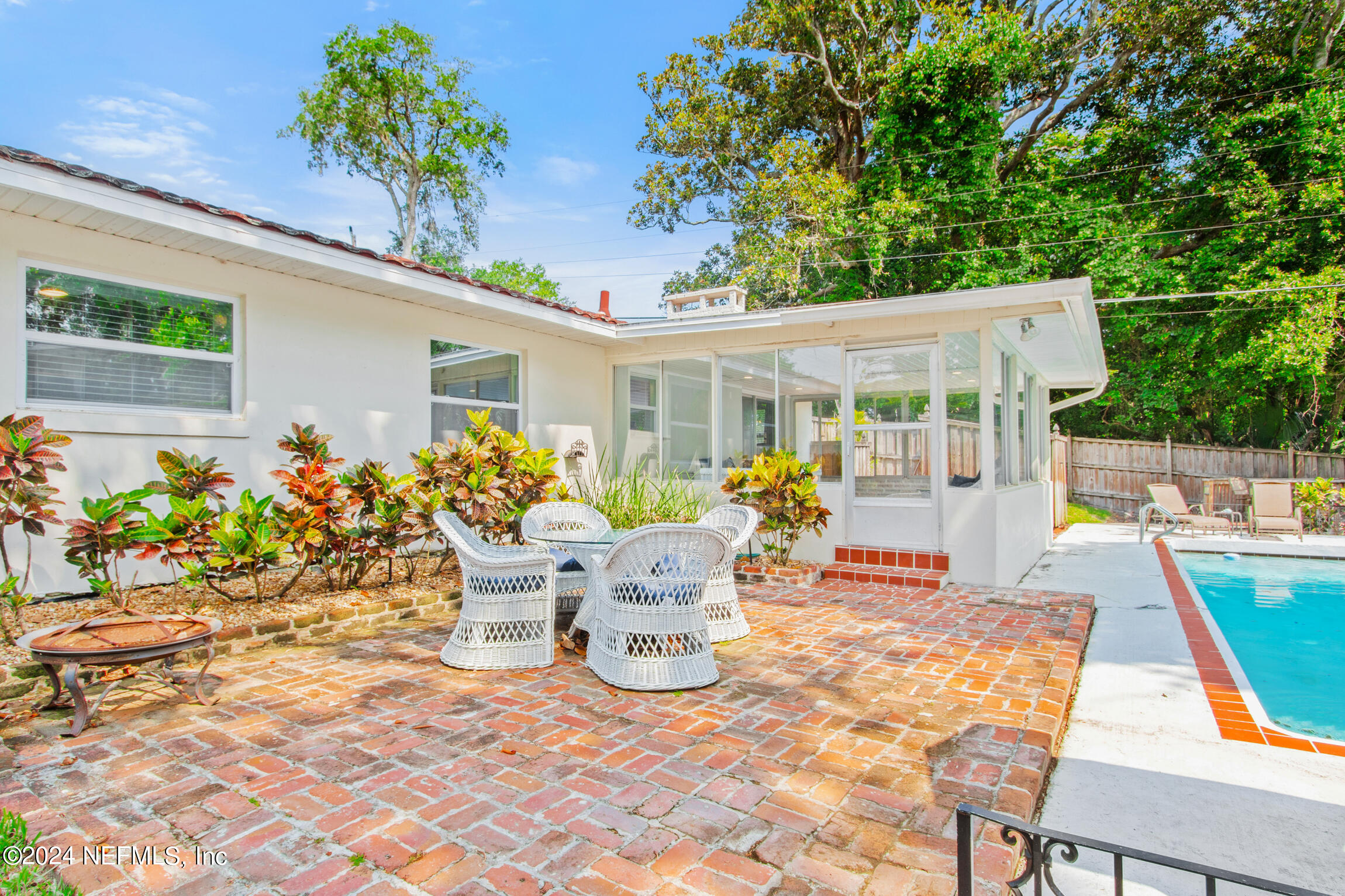 14 Park Terrace Drive St. Augustine, FL 32080 - Photo 20 of 42 a view of a patio with table and chairs potted plants with wooden floor and fence