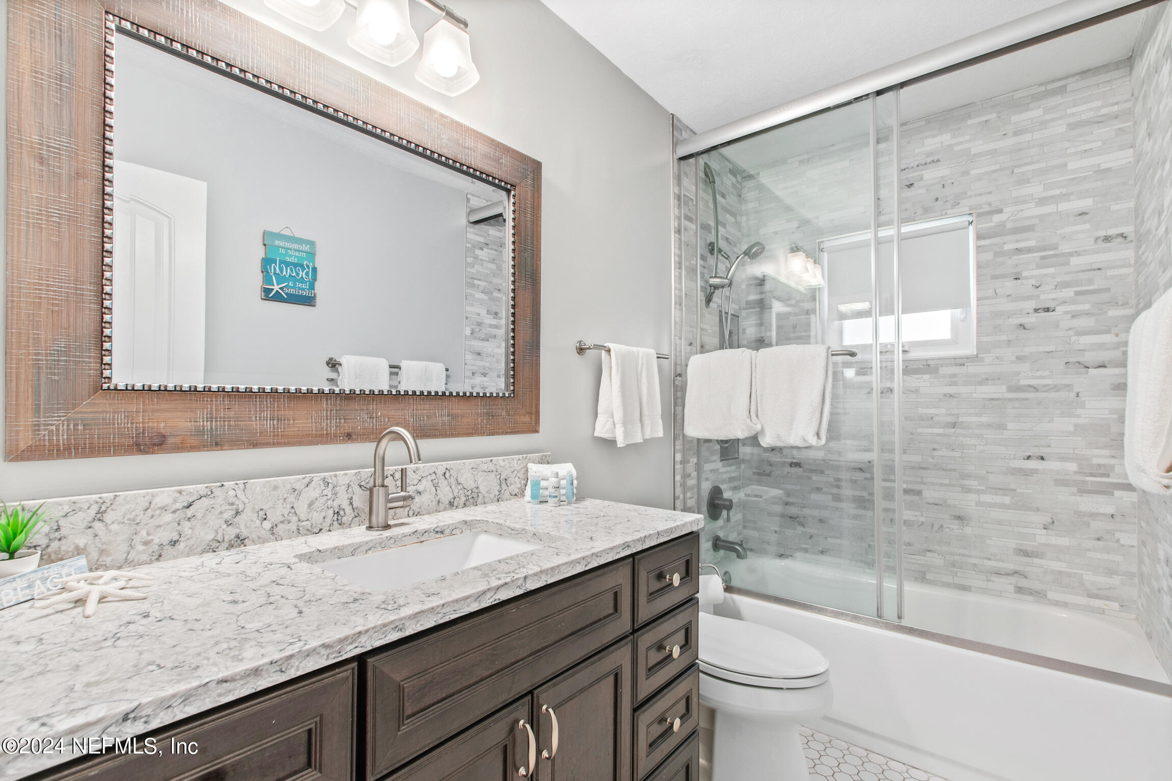 14 Park Terrace Drive St. Augustine, FL 32080 - Photo 33 of 42 a bathroom with a granite countertop sink a toilet a mirror and shower