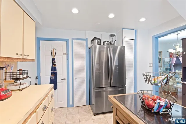 a kitchen with stainless steel appliances kitchen island granite countertop a refrigerator and a stove