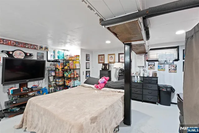 a bed room with a bed and a flat screen tv