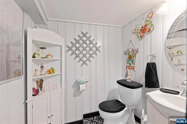 a bathroom with a sink mirror and toilet