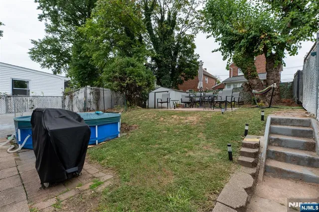 a view of a house with backyard porch and sitting area