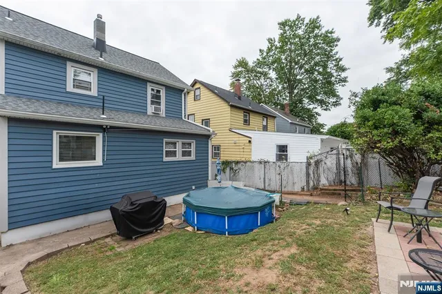 a view of a backyard with table and chairs