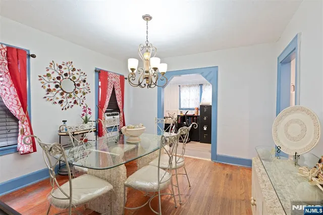 a view of a dining room with furniture and chandelier