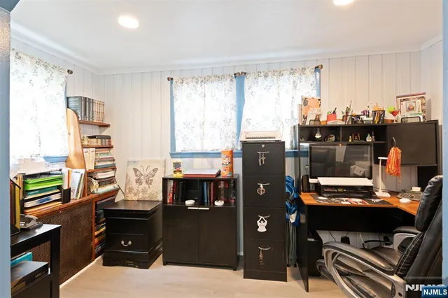 a room with a workspace and a window