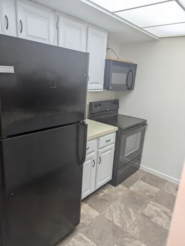 a kitchen with stainless steel appliances a refrigerator and a stove top oven