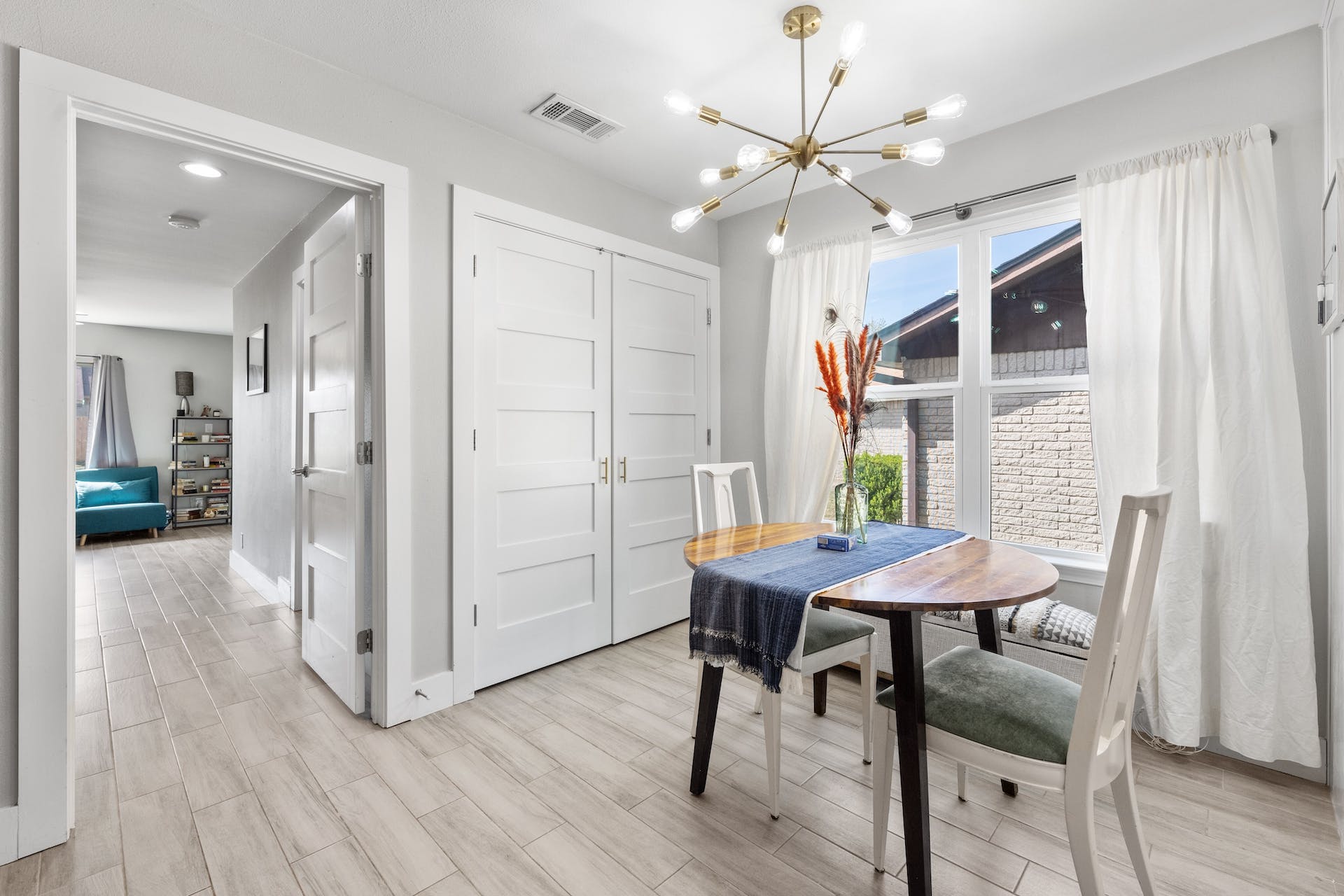 1400 Chippeway Lane Austin, TX 78745 - Photo 9 of 24 Dining room featuring a chandelier and wood tiled floors