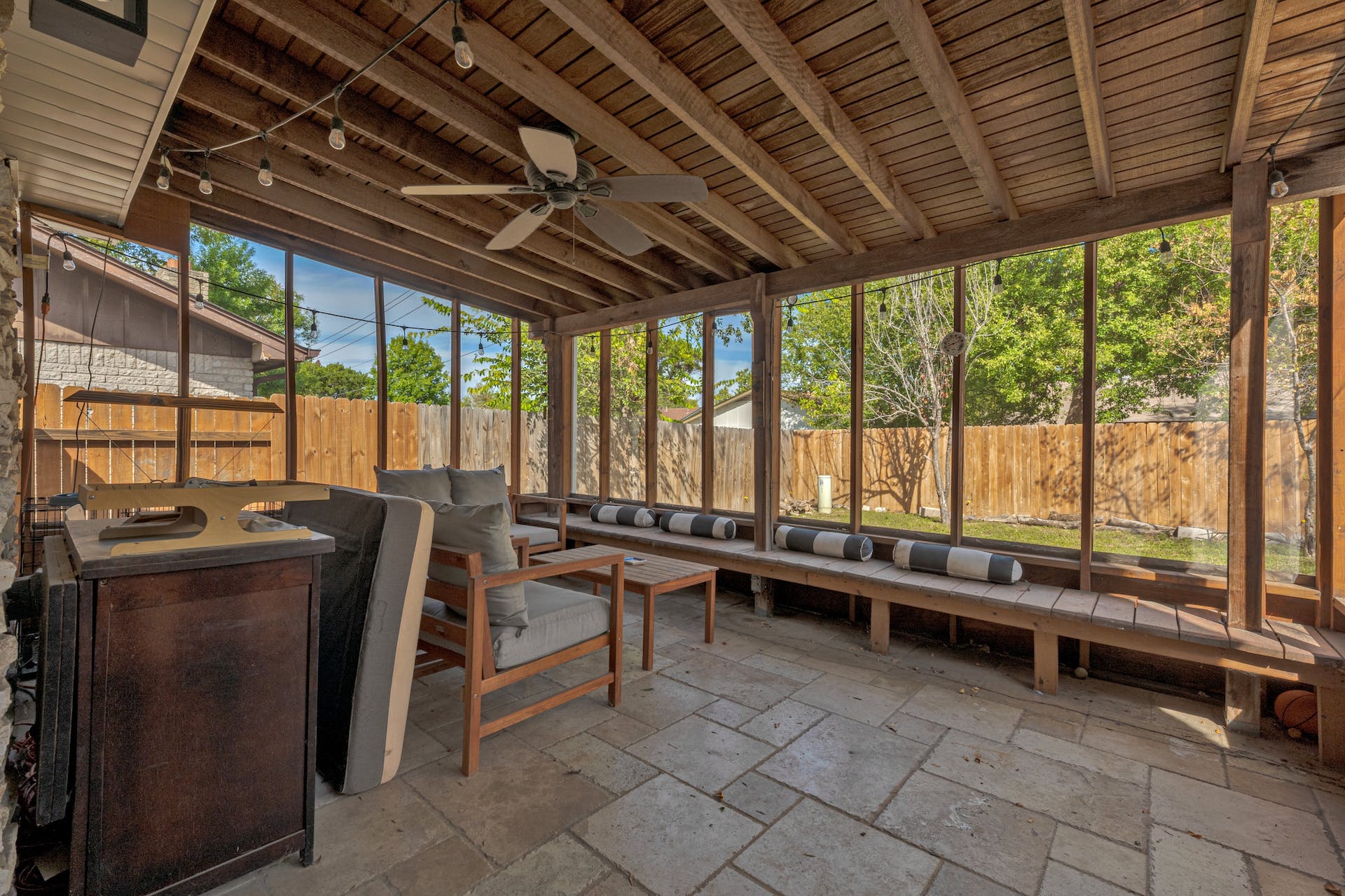 1400 Chippeway Lane Austin, TX 78745 - Photo 19 of 24 Sunroom with outdoor seating, ceiling fan, a patio area, and beam ceiling