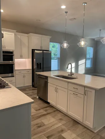 a kitchen with a sink refrigerator and microwave