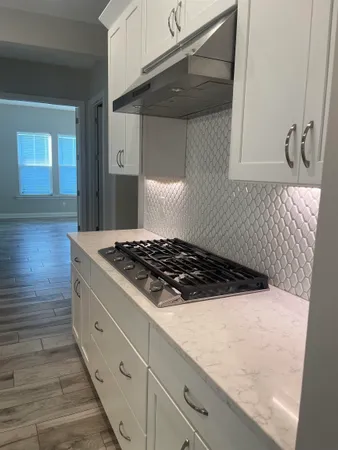 a stove top oven sitting inside of a kitchen