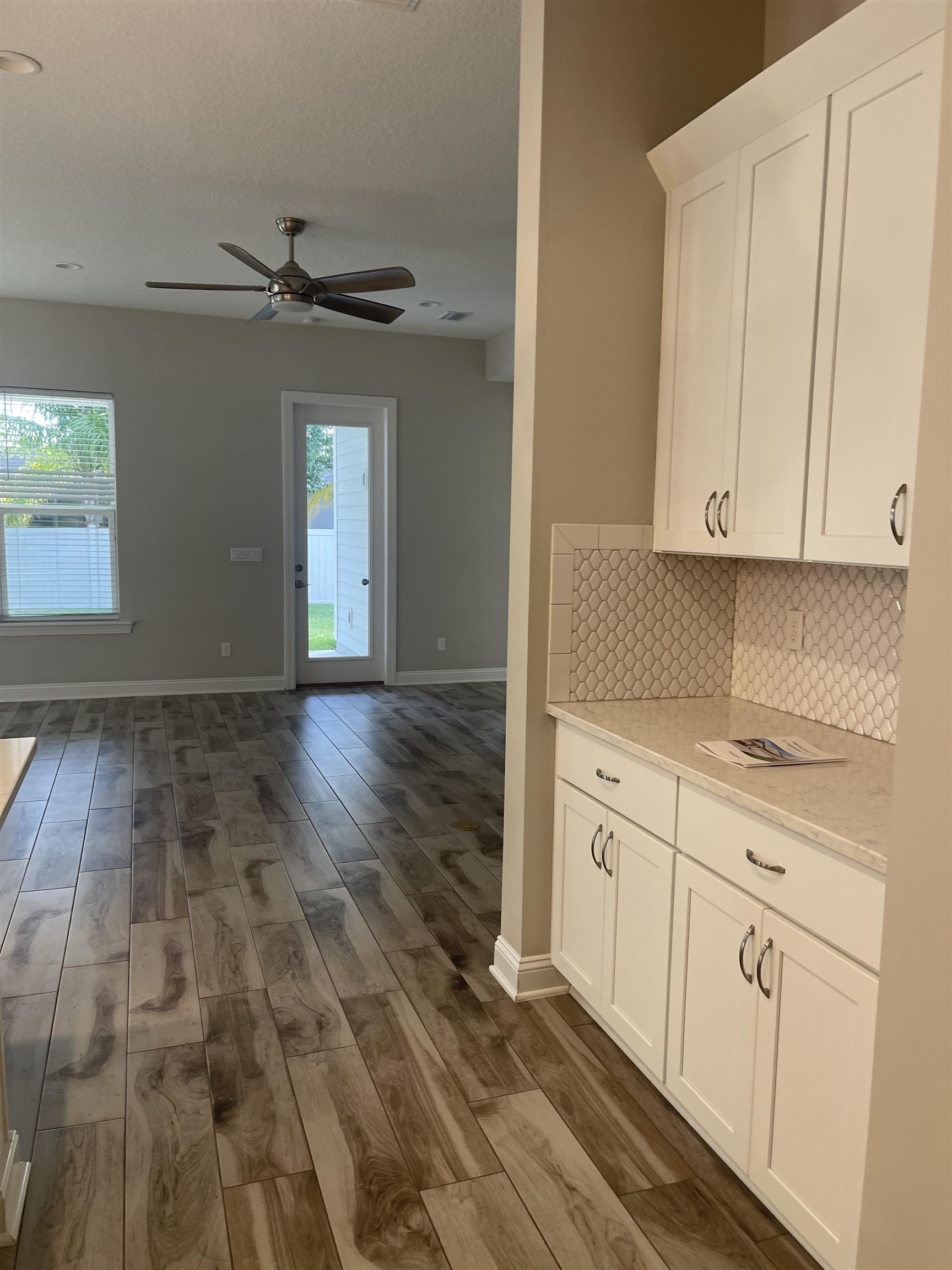 198 Paranza Trace St. Augustine, FL 32095 - Photo 5 of 23 a kitchen with granite countertop white cabinets and white appliances
