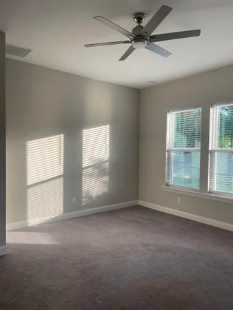 an empty room with a empty space and windows