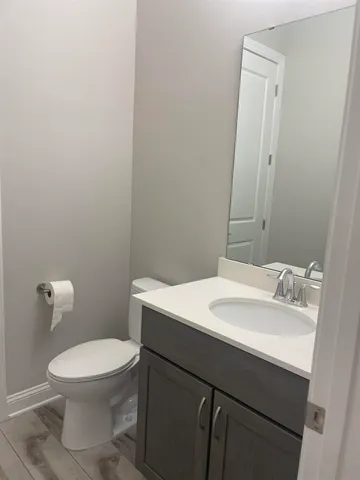 a bathroom with a sink a toilet and mirror