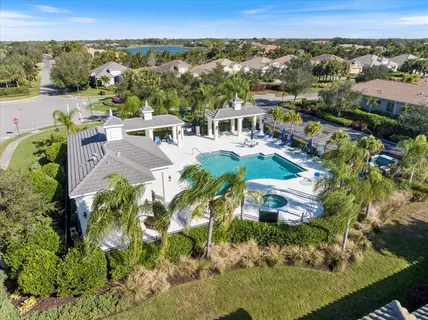 an aerial view of residential houses with outdoor space and street view