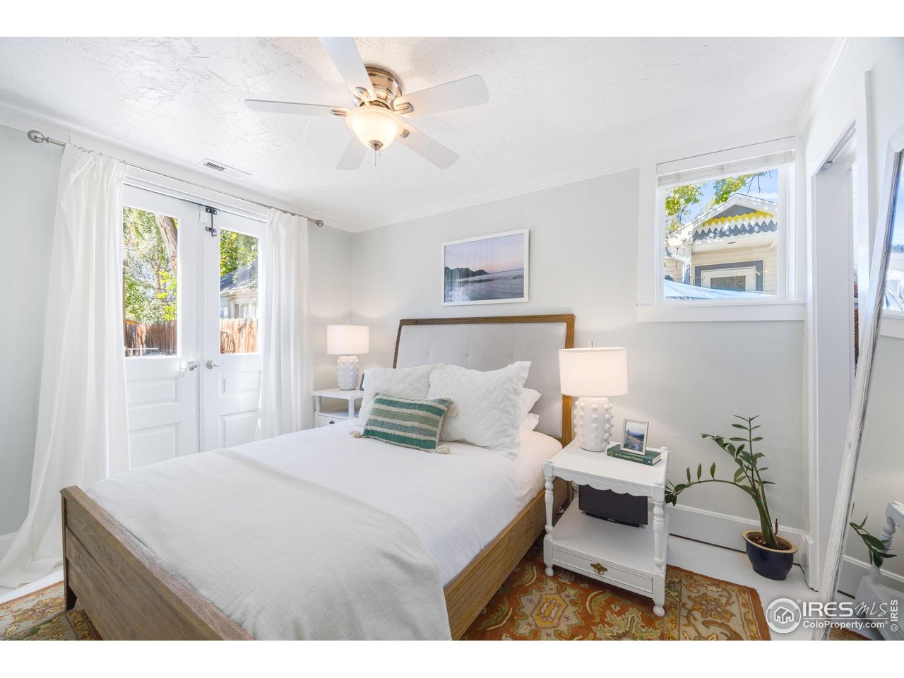 927 5th Street Berthoud, CO 80513 - Photo 19 of 35 a bedroom with a bed and a chandelier