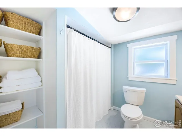 a bathroom with a toilet a sink and a mirror