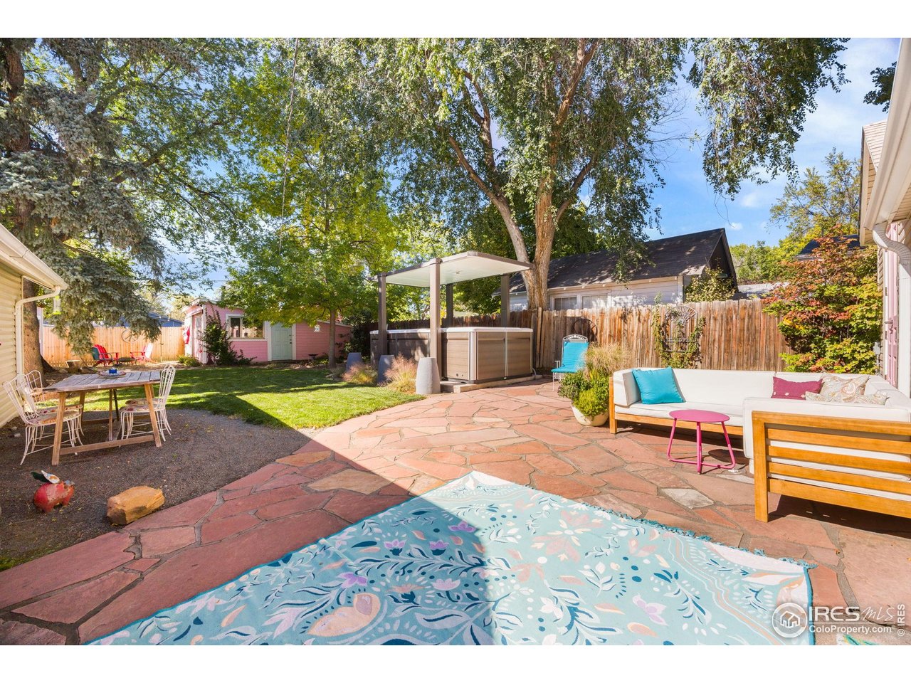 927 5th Street Berthoud, CO 80513 - Photo 27 of 35 a backyard of a house with barbeque oven table and chairs