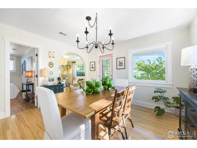 a view of a dining room with furniture and a chandelier