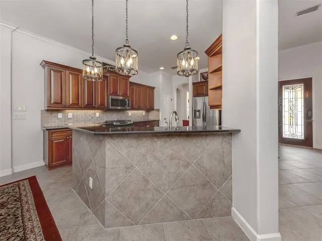 a view of a dining room with furniture and a chandelier