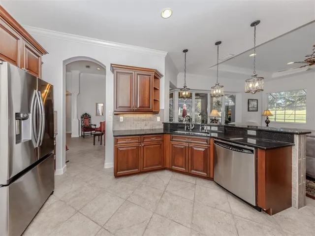 a kitchen with stainless steel appliances granite countertop a sink counter space and cabinets