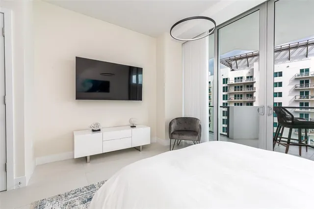 a bedroom with a bed and a flat screen tv