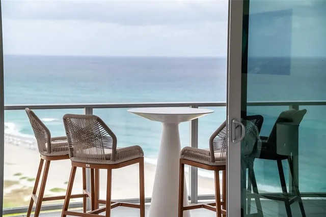 a view of balcony and dining area with furniture