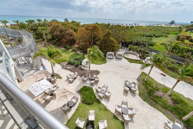 an aerial view of a swimming pool with a yard