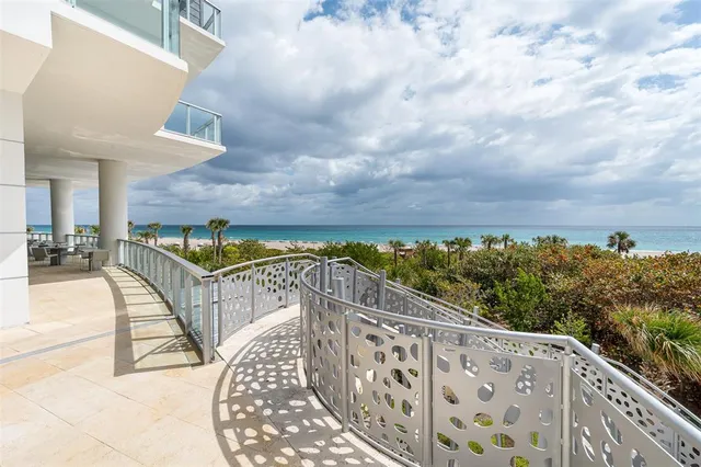 a view of balcony with wooden floor and seating space