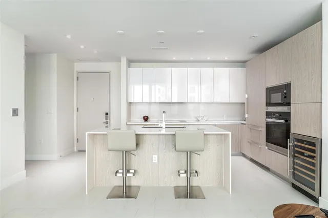 a kitchen with a sink cabinets and window