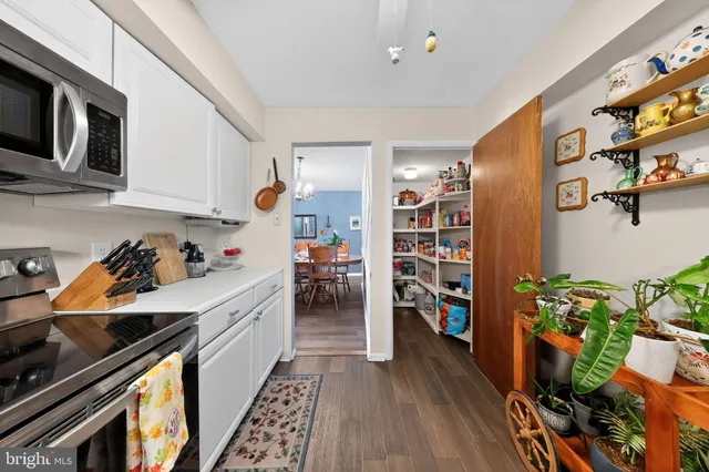 a kitchen with a refrigerator and a stove top oven