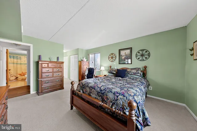 a bedroom with a bed and dresser