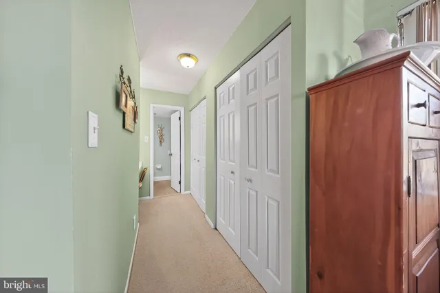 a view of a hallway with wooden floor and entryway