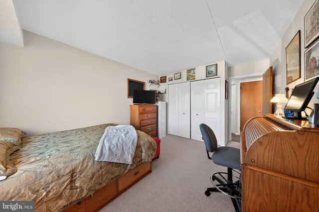 a bedroom with a bed and a mirror