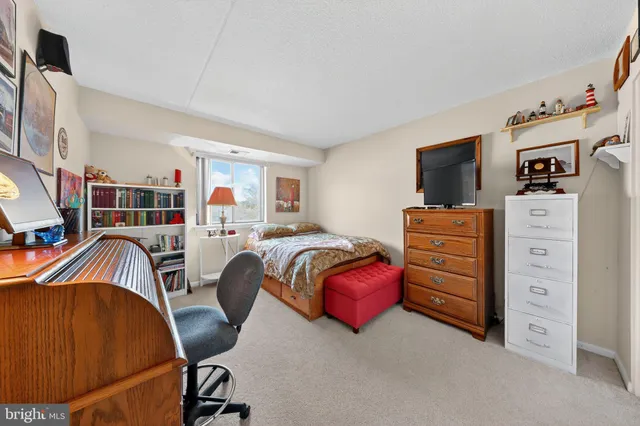 a bedroom with furniture and a flat screen tv