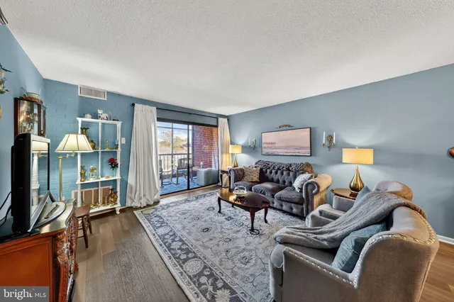 a living room with furniture a window and a flat screen tv
