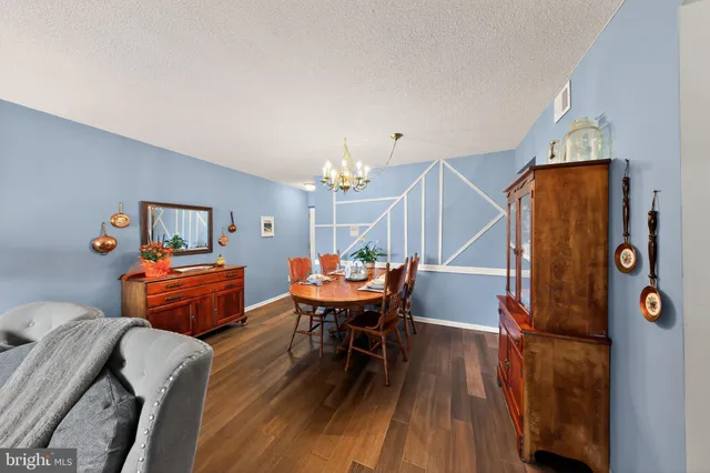 a dining room with furniture and wooden floor