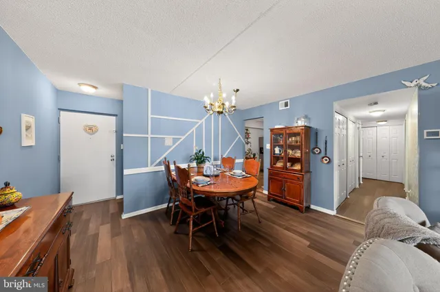 a dining room with furniture and wooden floor
