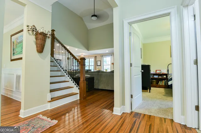 a view of a hallway view with wooden floor and staircase