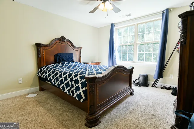 a bedroom with a bed and a large window